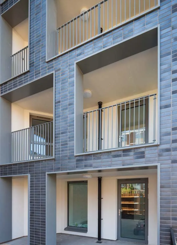 Brick apartment block with aluminium balcony and entrance doors