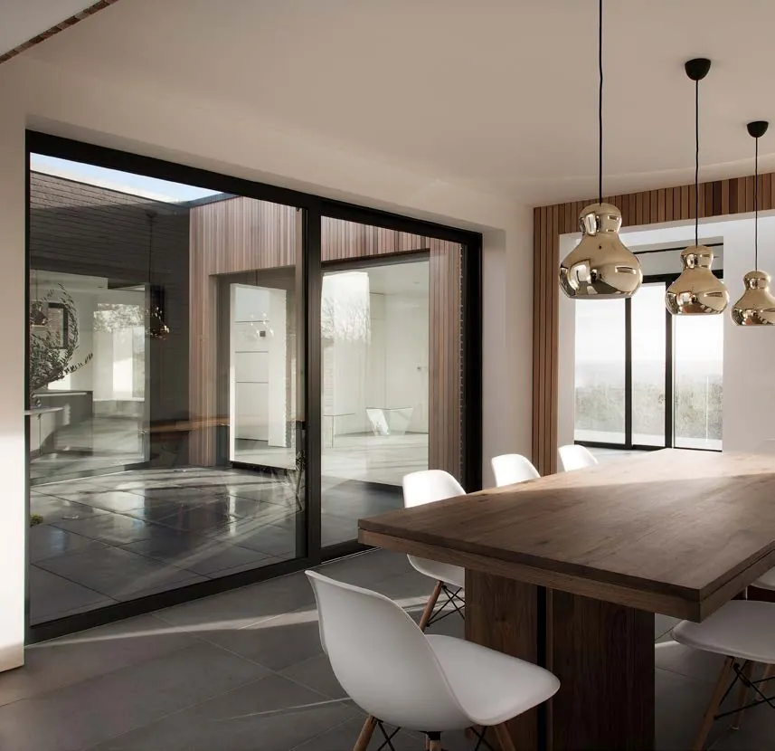 Dark aluminium in-line sliding doors in a kitchen dining room