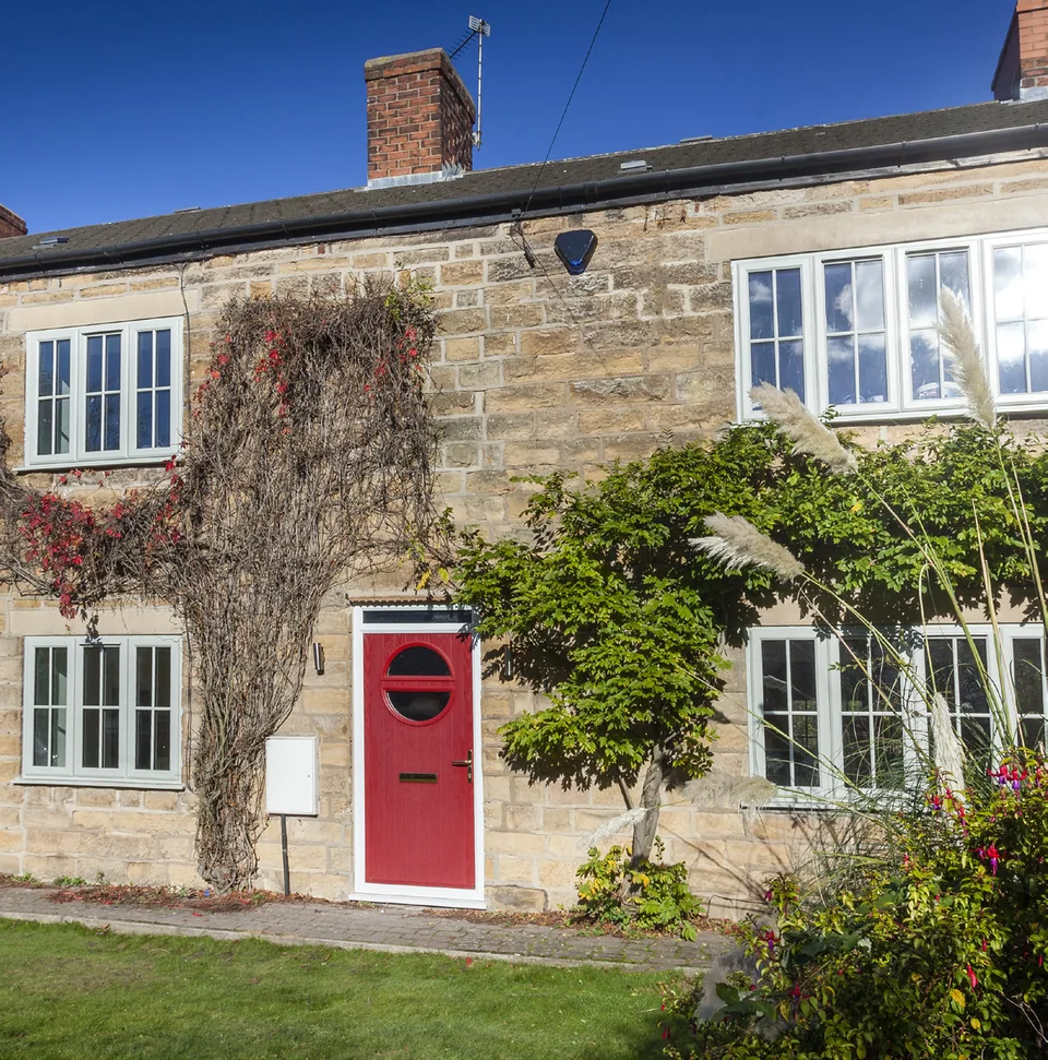 Stone cottage with a red composite front door and casement windows – Hale Windows And Doors
